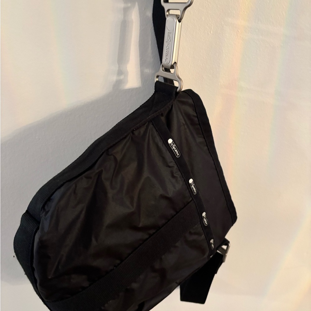 Black Le Sportsac Crossbody Bag with multiple pockets, brushed silver hardware.